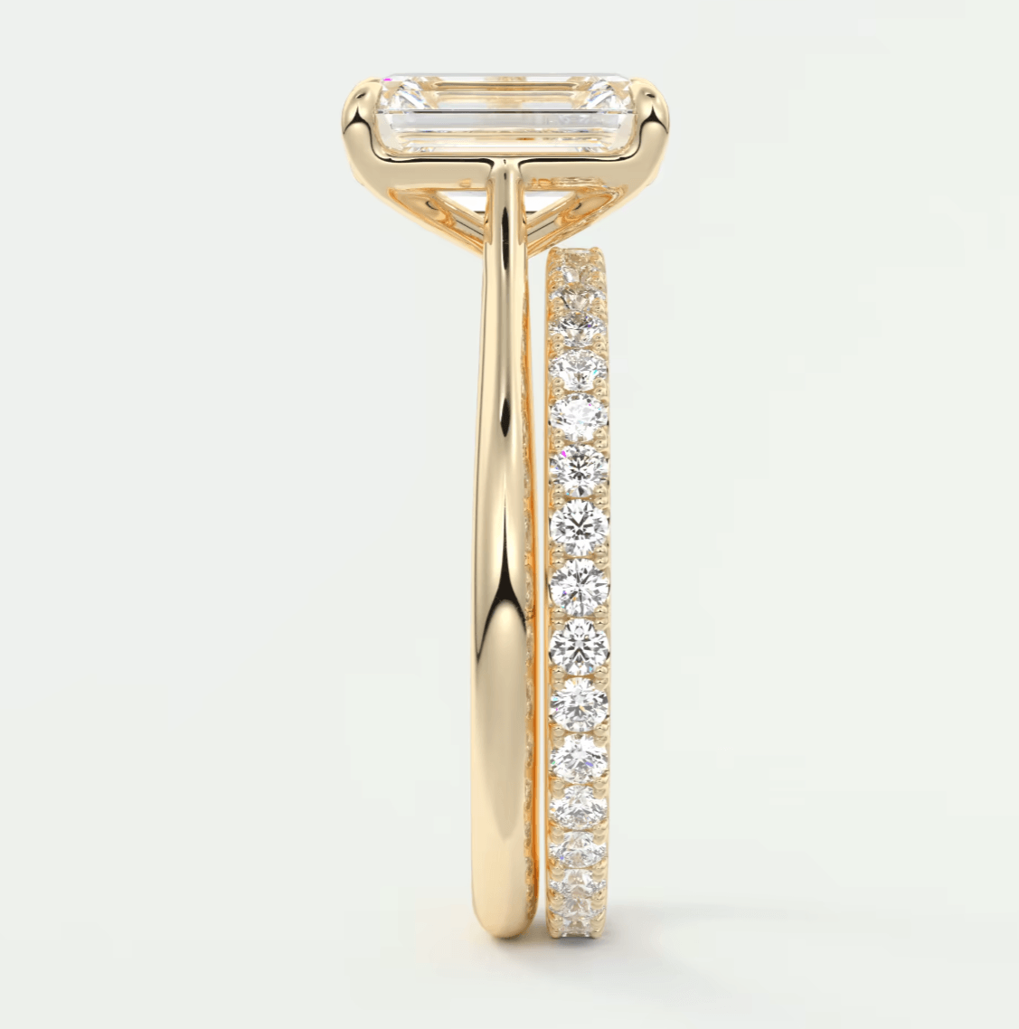 18k yellow gold diamond engagement ring with a baguette center stone and channel set diamonds on the band.