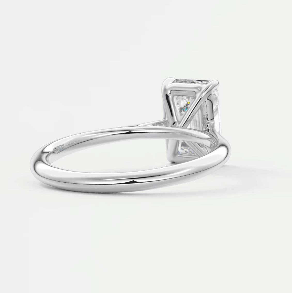 18k white gold diamond engagement ring with a princess cut center stone and small diamonds on the band.