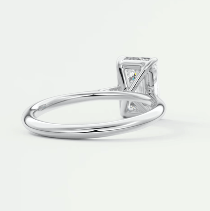 18k white gold diamond engagement ring with a princess cut center stone and small diamonds on the band.