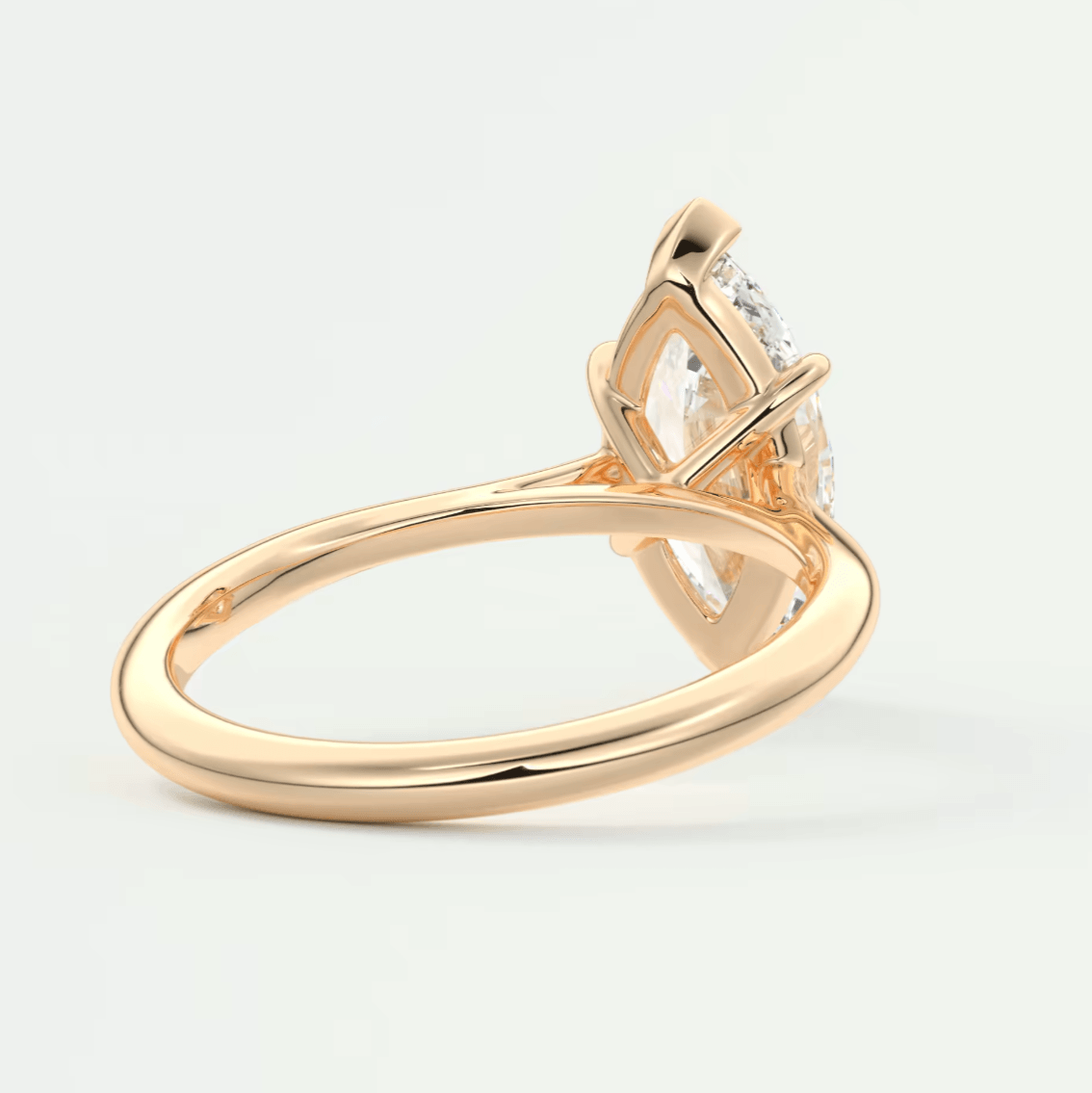 18k rose gold diamond engagement ring with marquise-cut gemstone.