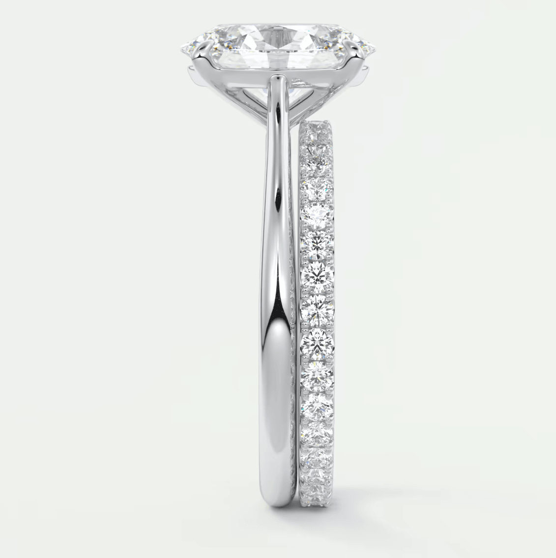 18-karat white gold engagement ring with a round diamond center and pavé-set diamonds on the band.