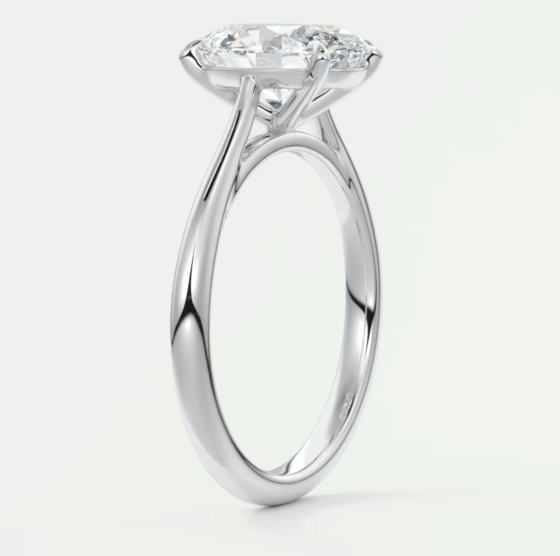 18-karat white gold solitaire engagement ring with a round diamond.