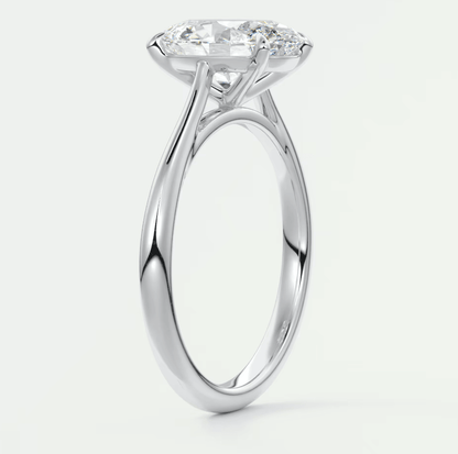 18-karat white gold solitaire engagement ring with a round diamond.