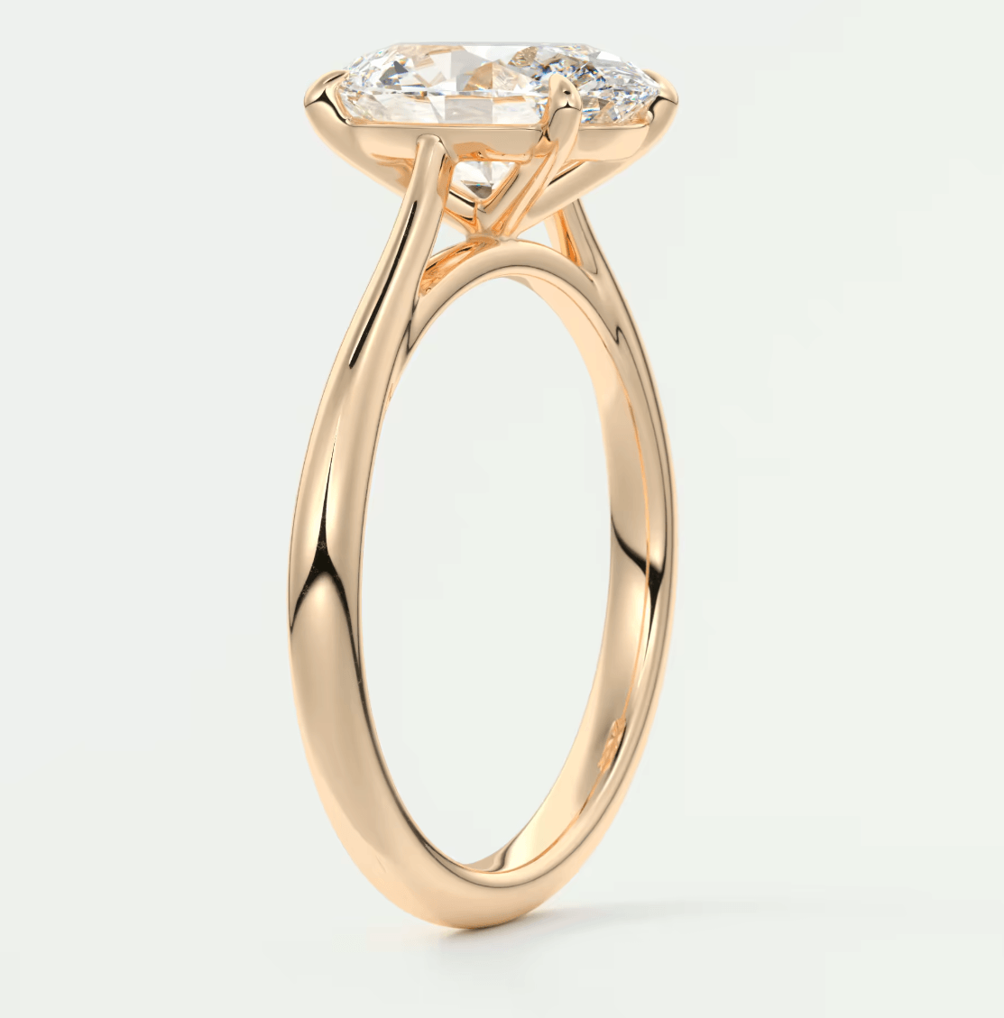 18-karat rose gold engagement ring with a marquise-cut diamond.