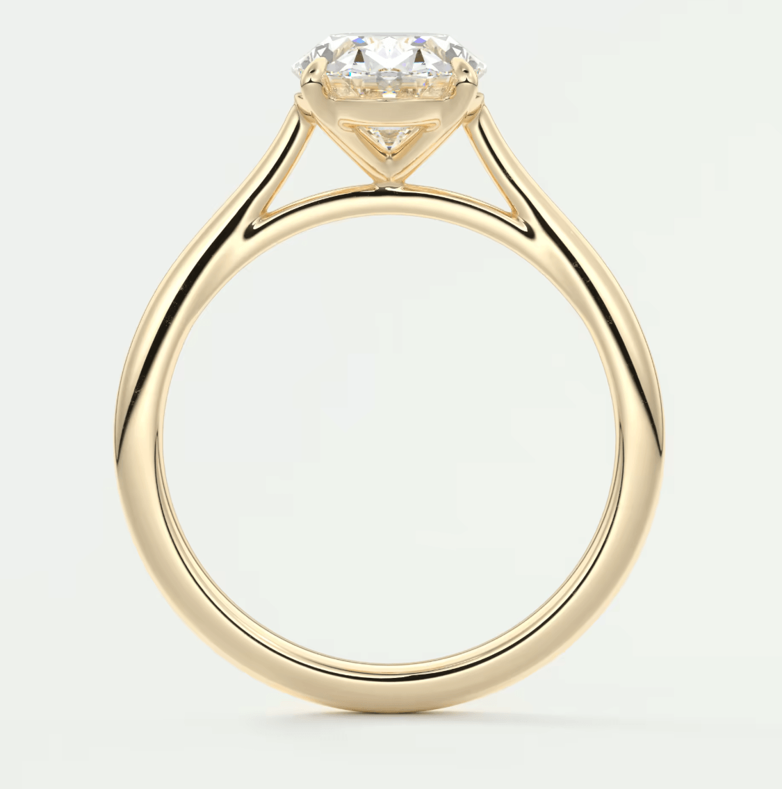 18-karat yellow gold solitaire engagement ring with a round diamond.