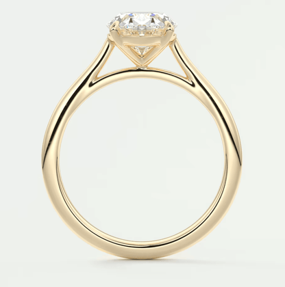 18-karat yellow gold solitaire engagement ring with a round diamond.