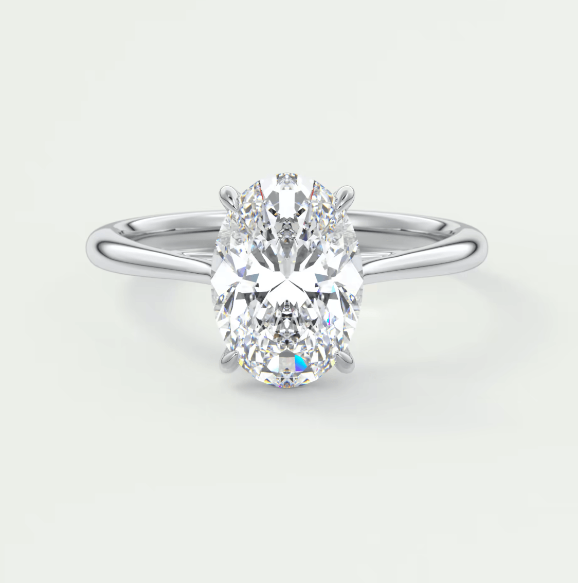 18k white gold oval diamond engagement ring with a solitaire setting.