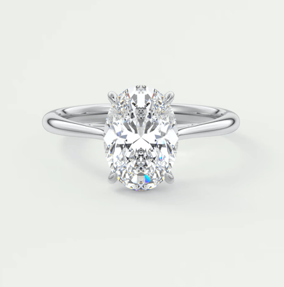 18k white gold oval diamond engagement ring with a solitaire setting.