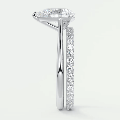 White gold diamond engagement ring set with a princess cut center stone and channel-set side stones.