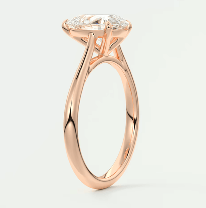 Rose gold engagement ring with a cushion-cut diamond.