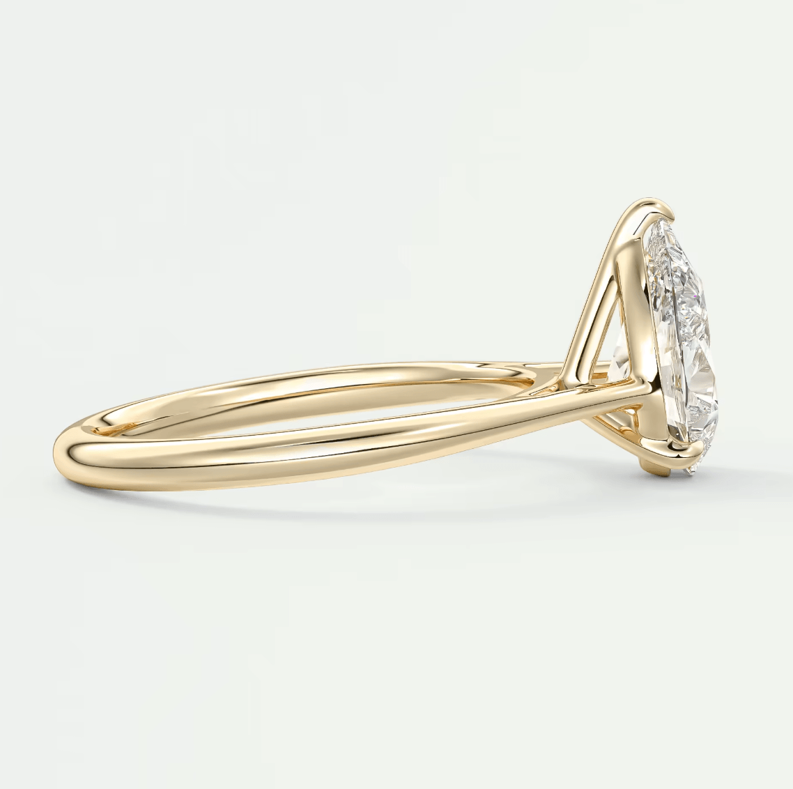 18k yellow gold diamond engagement ring with a marquise-cut center stone.