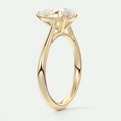 18-karat yellow gold engagement ring with a cushion-cut diamond.