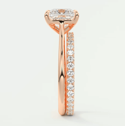 18k rose gold diamond engagement ring with a square-cut center stone and channel-set diamonds on the band.