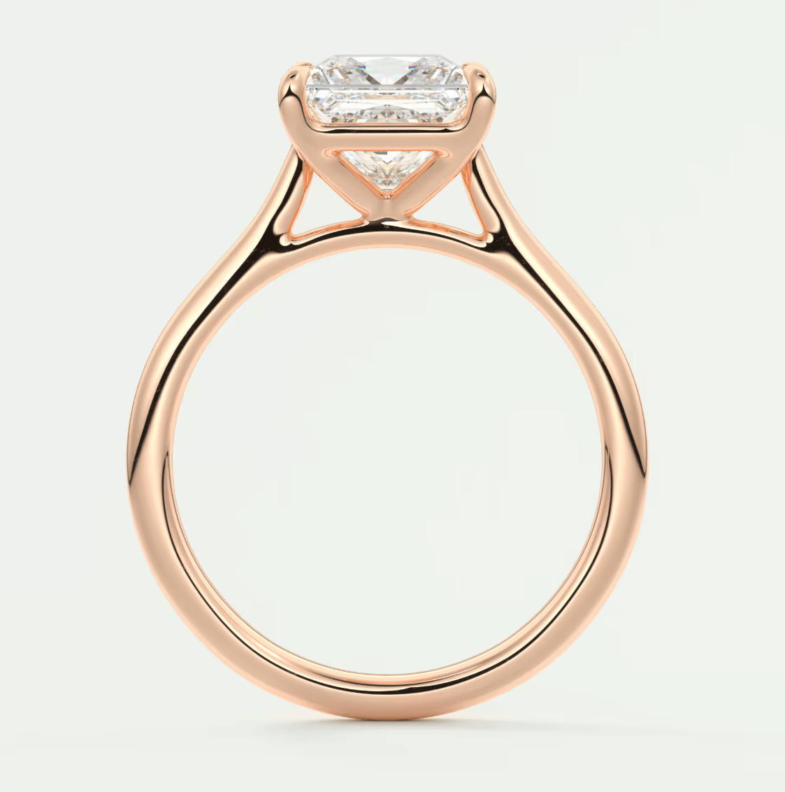 Rose gold princess cut diamond engagement ring with a twisted band design.