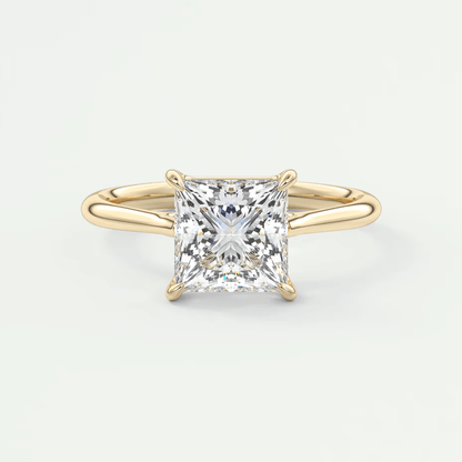 Princess cut diamond engagement ring with yellow gold band and prong setting.