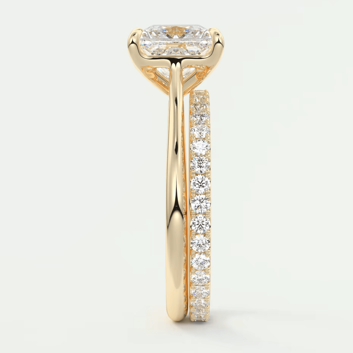 18k yellow gold engagement ring with a princess cut diamond and channel set diamonds on the band.