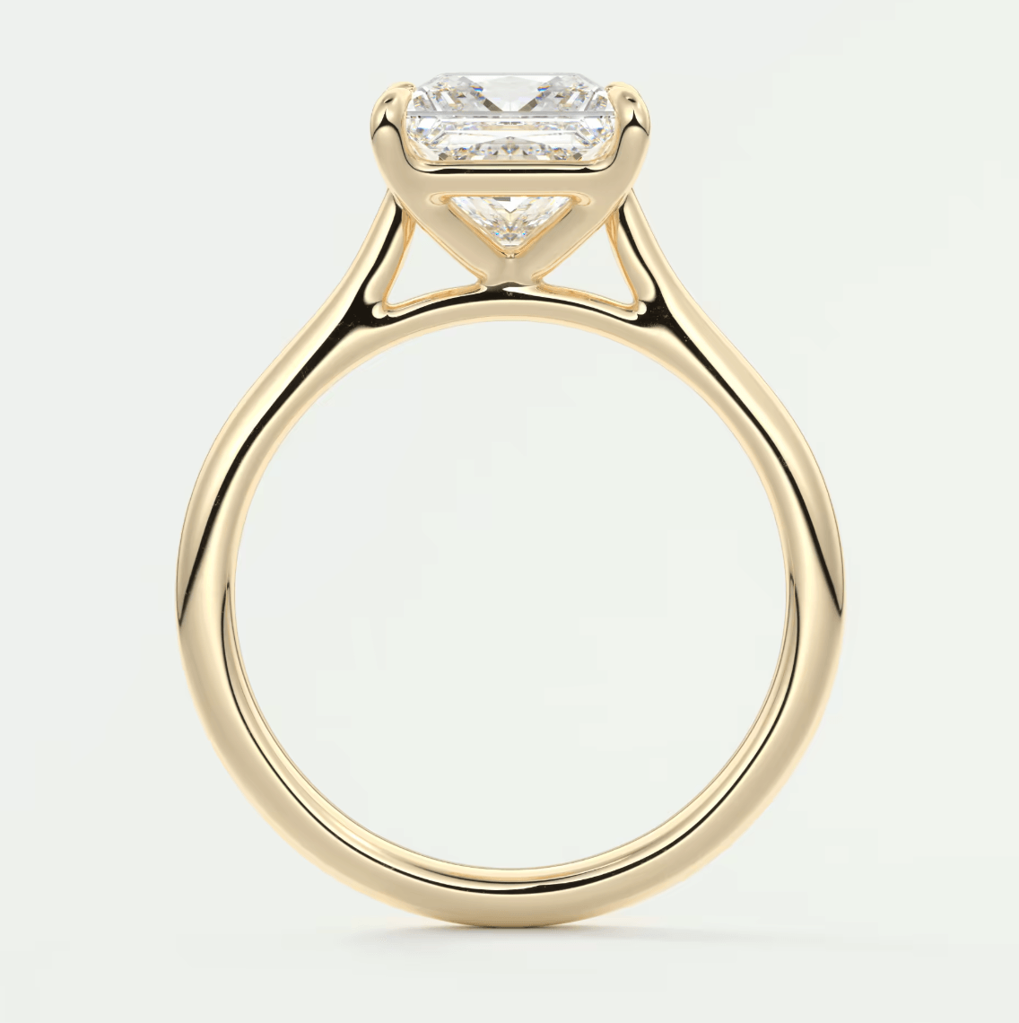18-karat yellow gold engagement ring with a princess-cut diamond.