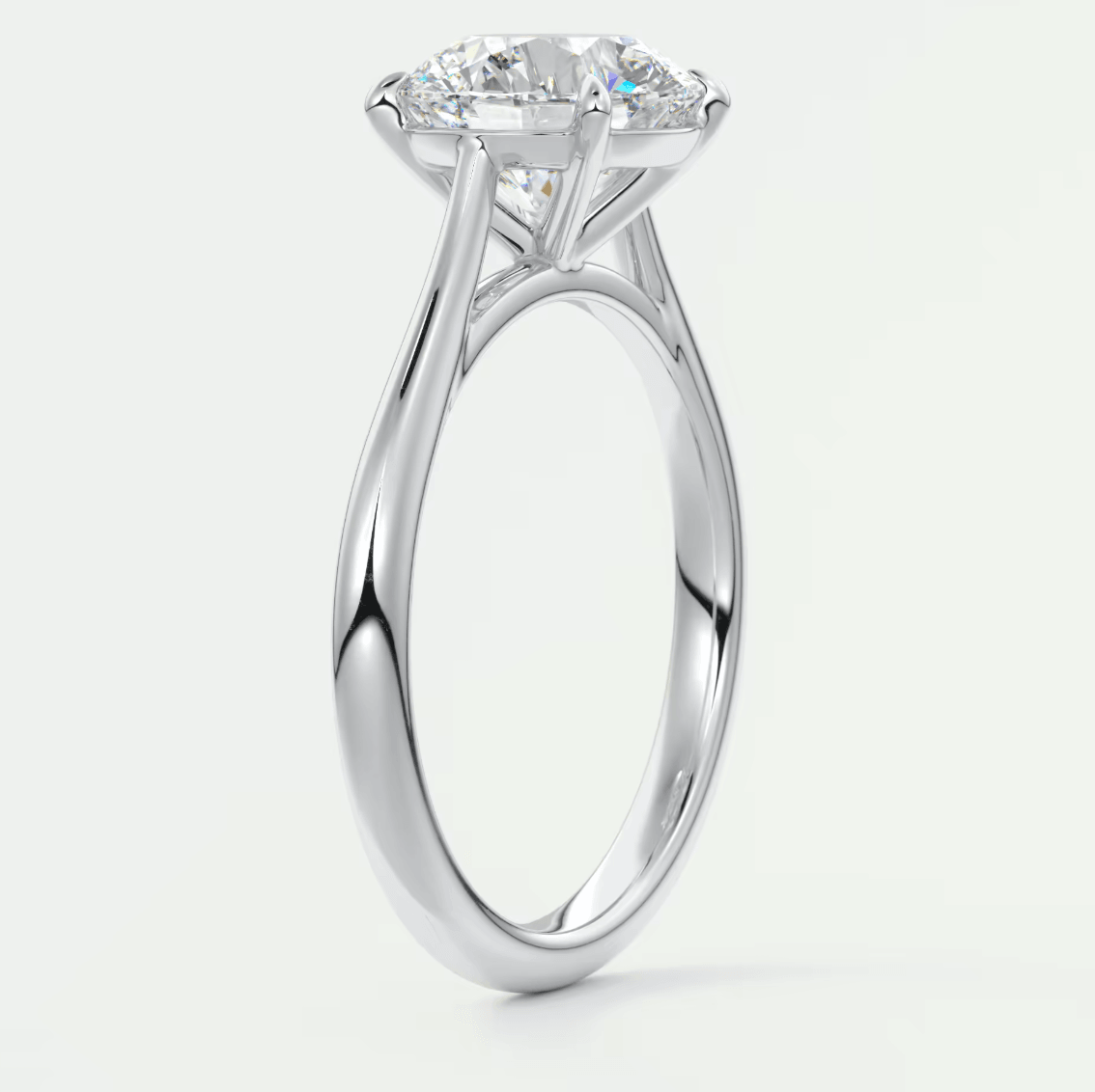 White gold solitaire diamond engagement ring with a cushion-cut center stone.