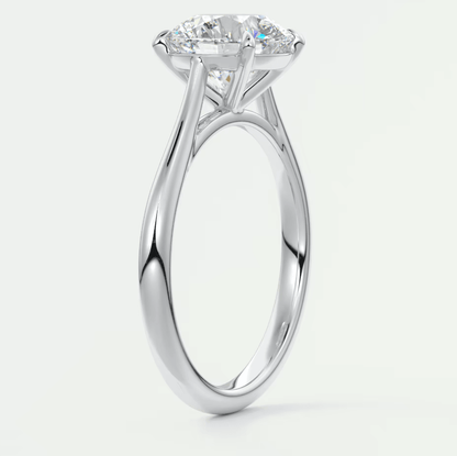 White gold solitaire diamond engagement ring with a cushion-cut center stone.