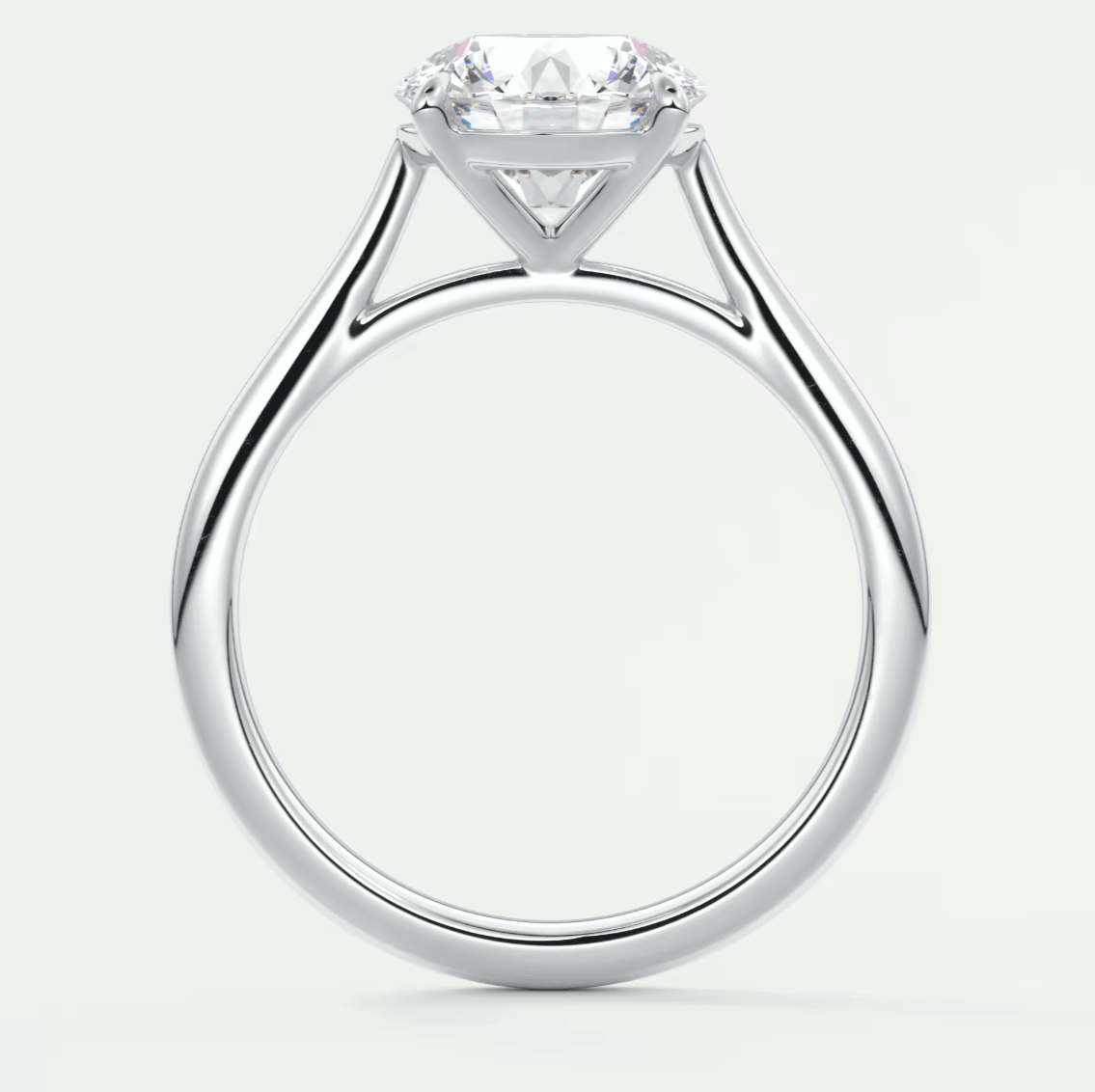 18k white gold solitaire diamond engagement ring with a cushion-cut center stone.
