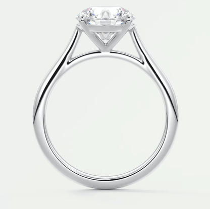 18k white gold solitaire diamond engagement ring with a cushion-cut center stone.