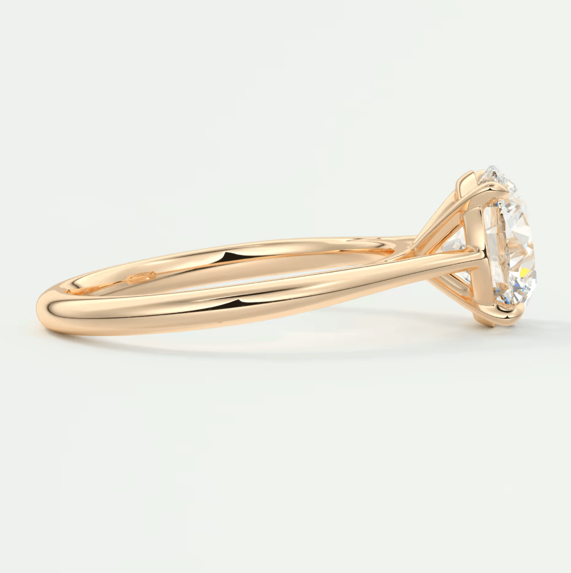 18k gold solitaire diamond engagement ring with a round brilliant cut stone.