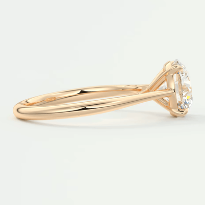 18k gold solitaire diamond engagement ring with a round brilliant cut stone.