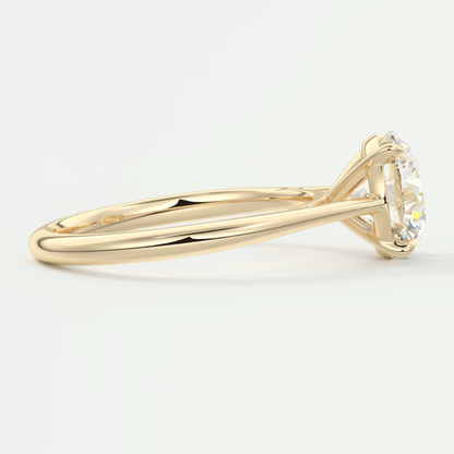 18-karat yellow gold solitaire engagement ring with a round diamond.