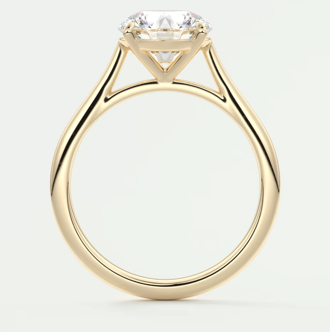 18k yellow gold engagement ring with a cushion-cut diamond.