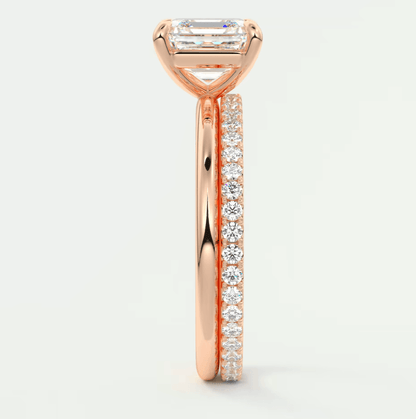 18k rose gold engagement ring with a princess cut diamond and pave set diamonds on the band.