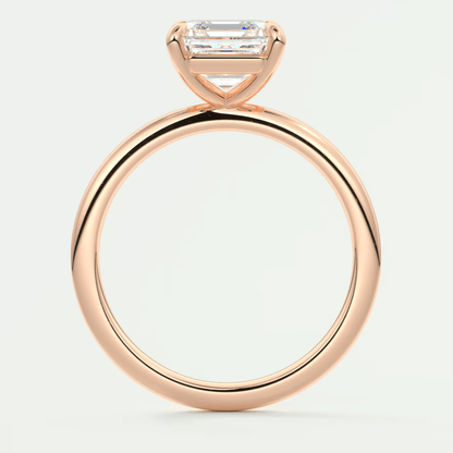 18-karat rose gold engagement ring with a baguette-cut diamond.
