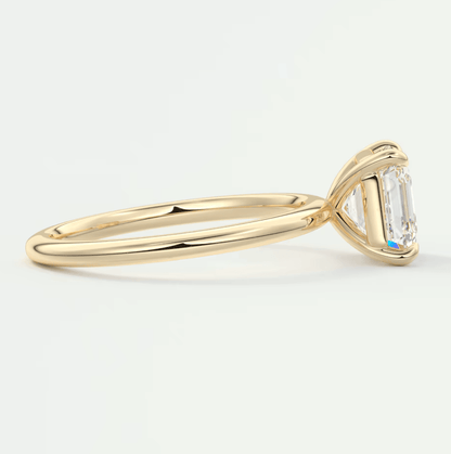 18k yellow gold engagement ring with an emerald-cut diamond.