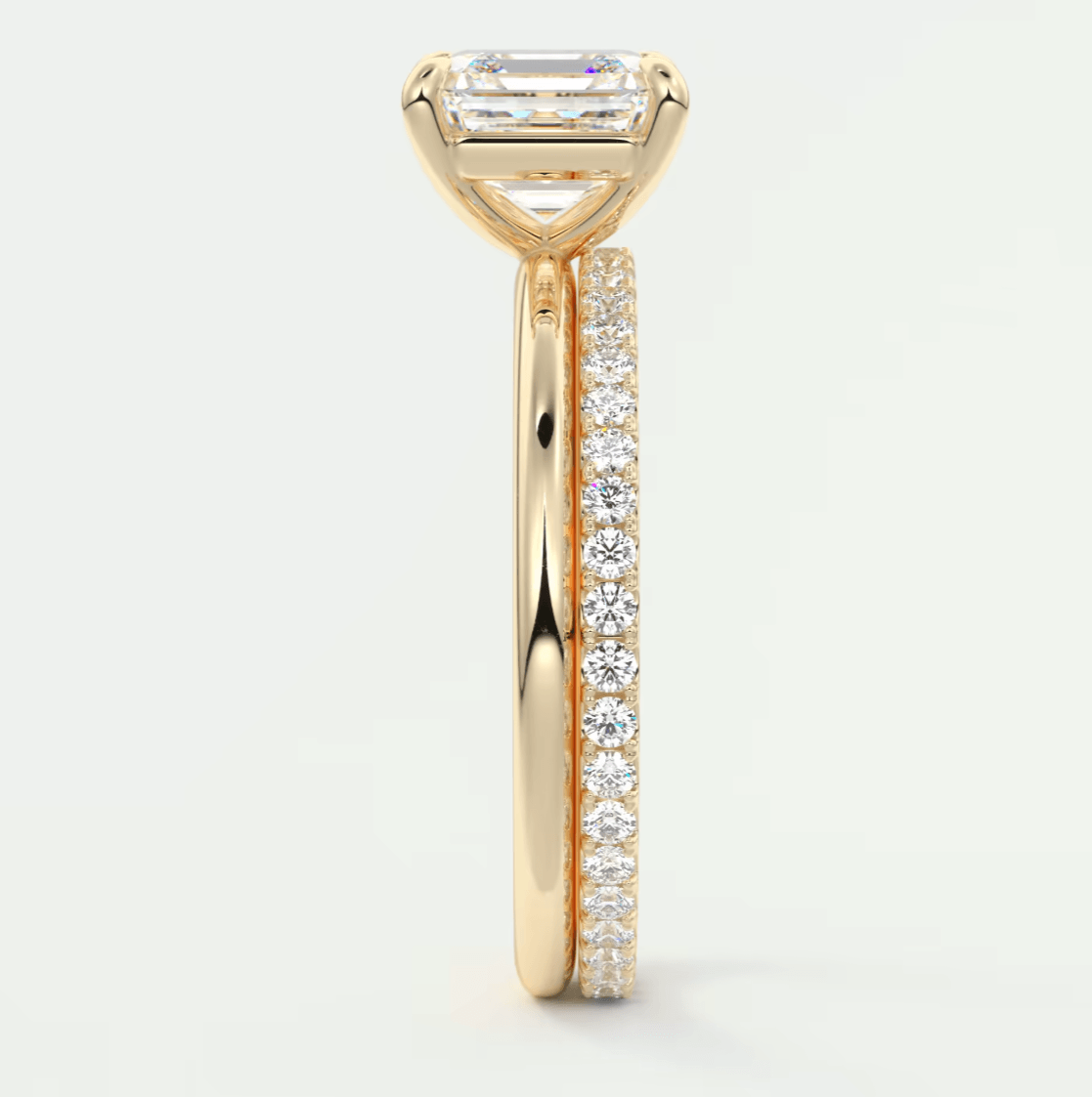18k yellow gold engagement ring with a baguette diamond center and channel-set diamonds on the band.
