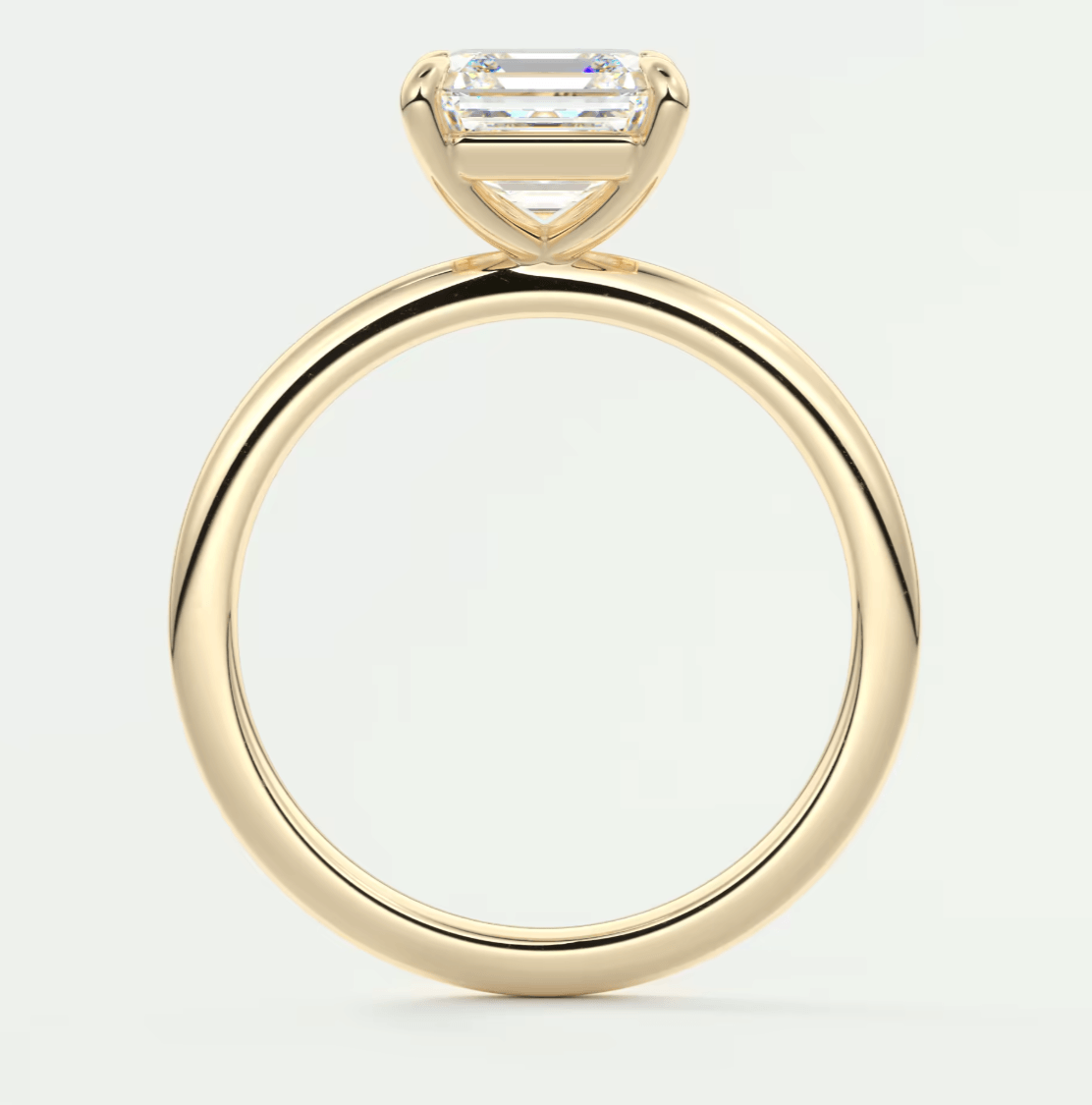 18k yellow gold engagement ring with a baguette-cut diamond.