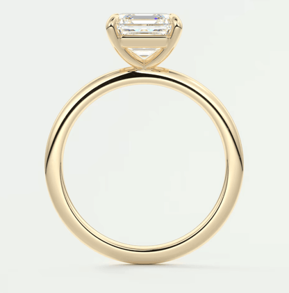 18k yellow gold engagement ring with a baguette-cut diamond.