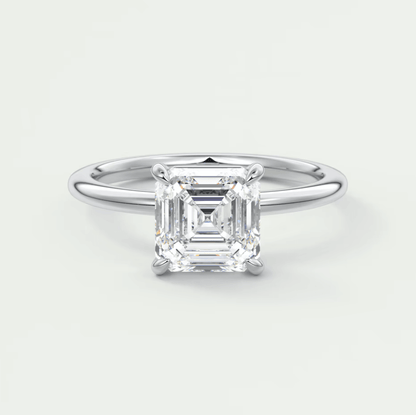 Asscher cut diamond engagement ring with white gold band.