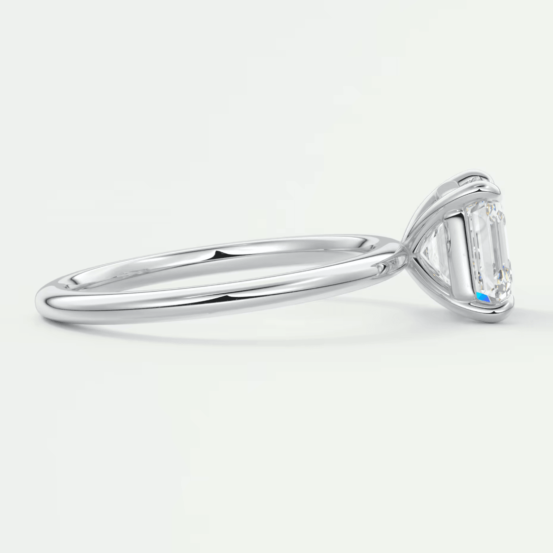 18k white gold engagement ring with a baguette-cut diamond.