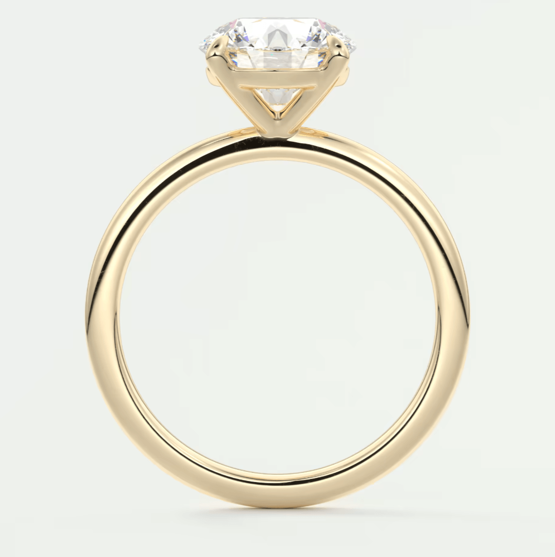 18k yellow gold solitaire engagement ring with a round diamond.