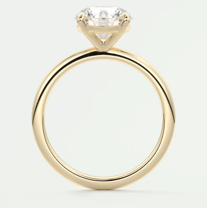 18k yellow gold solitaire engagement ring with a round diamond.