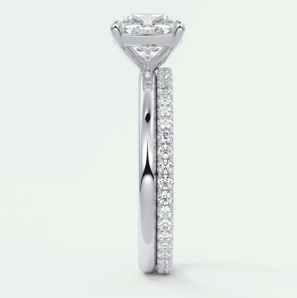 18k white gold diamond engagement ring with a princess cut center stone and pavé set diamonds on the band.