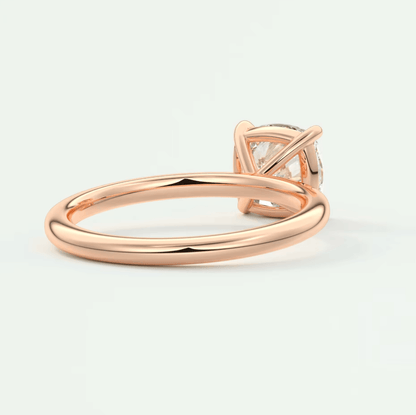 Rose gold diamond engagement ring with a princess cut gemstone and delicate band design.