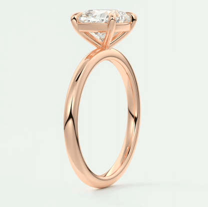 18k rose gold engagement ring with a princess cut diamond and small side diamonds.