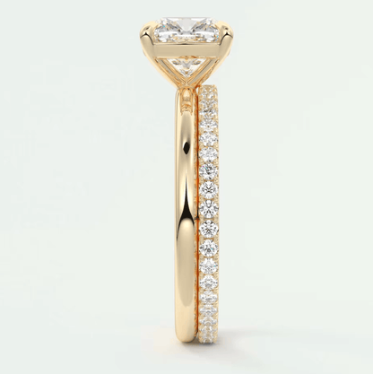 18k yellow gold engagement ring with princess cut diamond and pave set diamonds on the band.