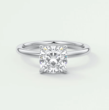 Cushion-cut diamond engagement ring with four prongs, platinum or white gold.