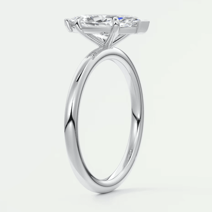 18-karat white gold solitaire engagement ring with a cushion-cut diamond.