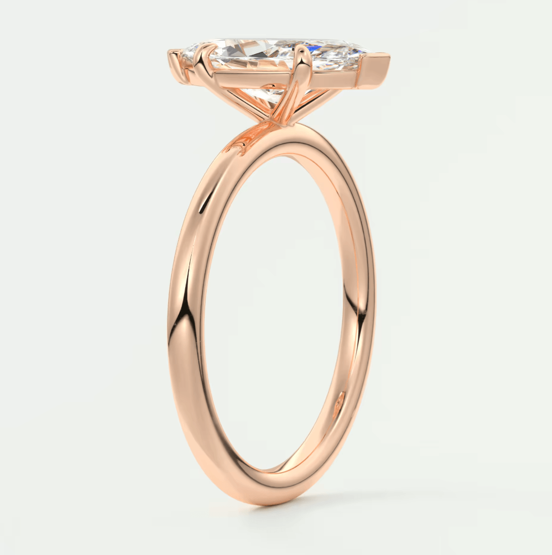 18k rose gold engagement ring with a marquise-cut diamond.