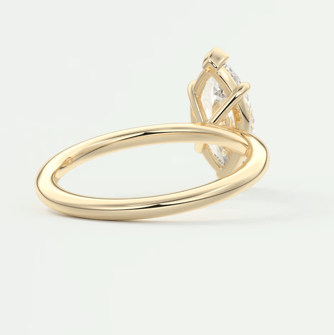 18-karat gold engagement ring with a marquise-cut diamond.