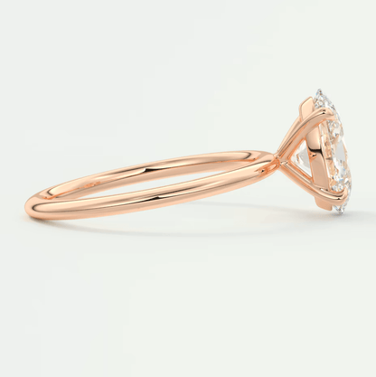 18k rose gold diamond engagement ring with a marquise-cut center stone and small diamonds on the band.