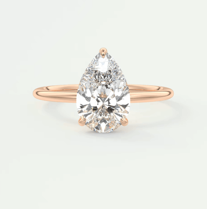 Rose gold pear-shaped diamond engagement ring with a solitaire design.
