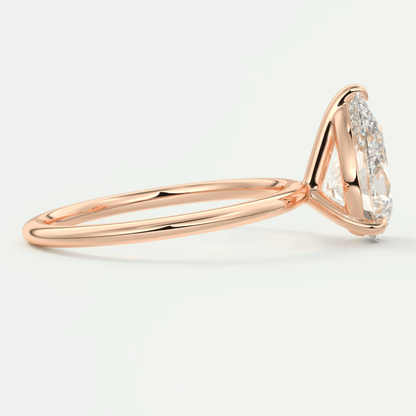 18k rose gold diamond engagement ring with a marquise-cut center stone and pave-set diamonds on the band.